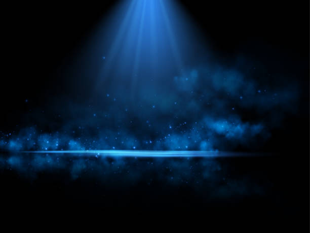 istock A glowing blue spotlight illuminates a misty scene with sparkling particles scattered in the dark background, creating a mysterious and ethereal atmosphere, perfect for abstract or cosmic themes. 2196155439