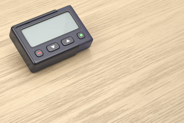 istock Retro pager on wooden desk 2196155455