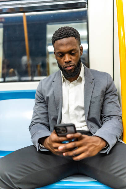 istock Young businessman using his smartphone while traveling by subway train 2196157760