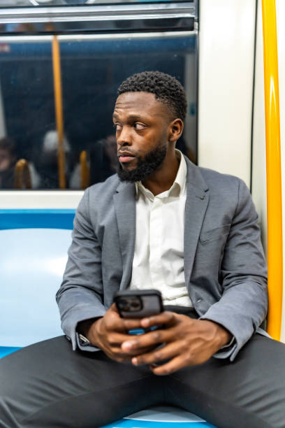 istock Young businessman using smartphone while traveling by subway train 2196157762