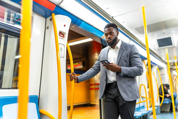 istock Businessman using smartphone on public transport 2196157778