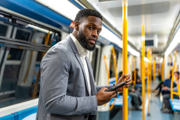 istock Businessman using smartphone on public transport 2196157834