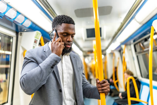 istock Young businessman talking on the phone while commuting by subway train 2196157934