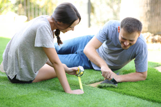 istock Happy couple installing artificial grass at home 2196158249