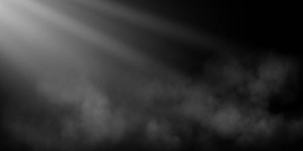 istock A dim spotlight casts soft beams of light through a hazy, fog-like texture against a dark background, evoking a somber and atmospheric mood, ideal for dramatic or abstract visuals. 2196158639