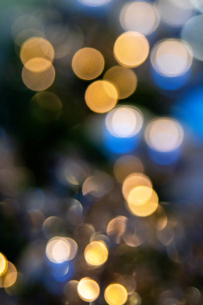 istock Yellow bokeh light on blue background. Abstract defocused lights. 2196159528