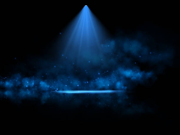 istock A glowing blue spotlight illuminates a misty scene with sparkling particles scattered in the dark background, creating a mysterious and ethereal atmosphere, perfect for abstract or cosmic themes. 2196159983
