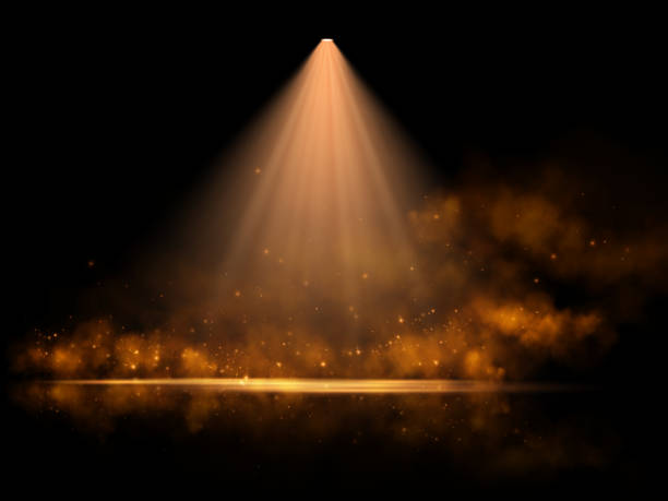 istock A dramatic golden spotlight illuminates a dark stage, surrounded by shimmering particles and a warm, ethereal glow, creating a mystical and elegant atmosphere with subtle reflections. 2196160010