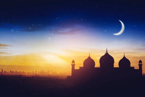 istock Silhouette of a Mosque at Sunset with Crescent Moon and Starry Sky 2196160413