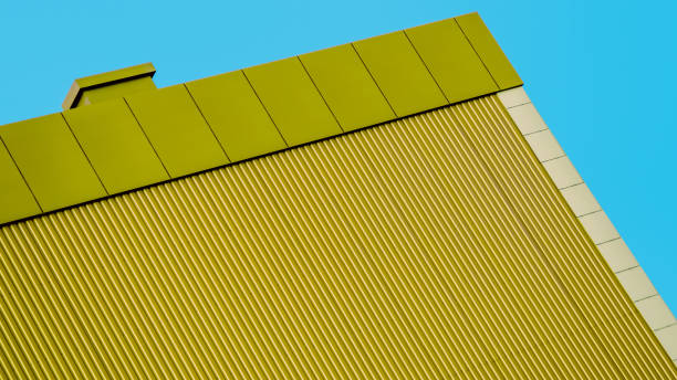istock orange wall of a modern building against a blue sky 2196161181