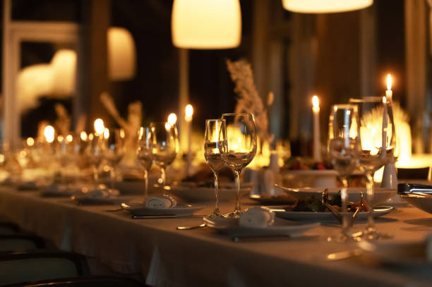 istock Elegant evening dining with candlelight and fine table settings in a modern restaurant 2196163526