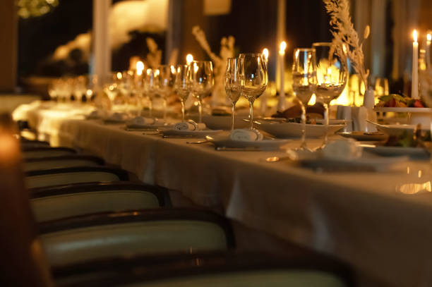 istock Elegant dining setup with candles and glassware in a warm atmosphere 2196163550