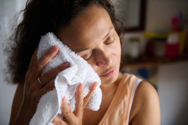istock Woman Gently Caring For Her Skin Using a Soft Towel at Home 2196170107