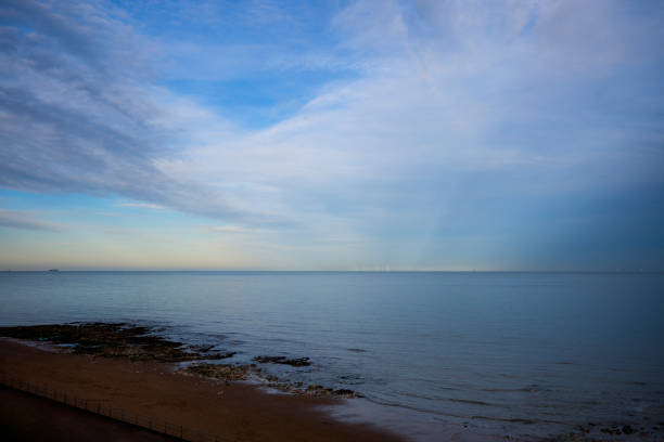 A wide angle shot of wind turbines off the coast of Kent.