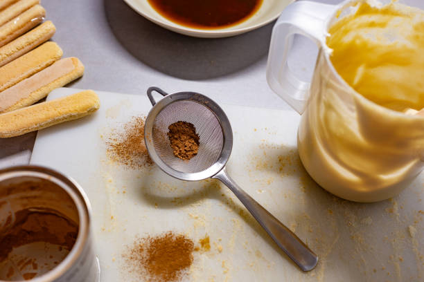Spain. Overhead view of a kitchen counter with scattered ingredients, showing the ongoing process of making tiramisu.