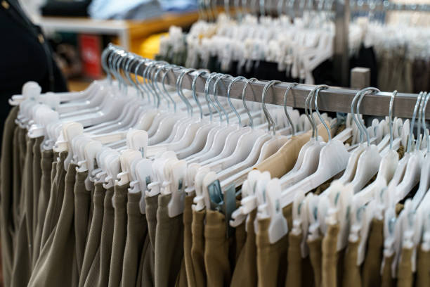 istock Array of stylish clothing displayed neatly on hangers in a retail store 2196175436
