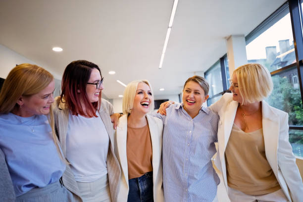 istock Businesswomen standing in the circle and hugging 2196179545