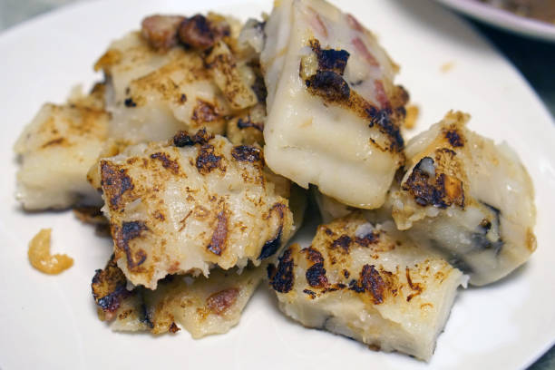 This delicious photograph presents a plate of perfectly pan-fried radish cake, also known as turnip cake or \