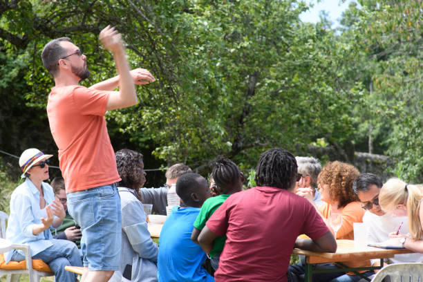 istock A man gets up from the table and throws something at a gathering of friends 2196181251