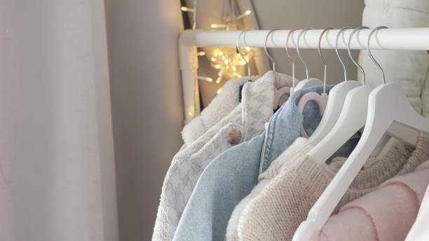 istock Organizing fresh spring wardrobe with vibrant and pastel clothing on racks. 2196181565