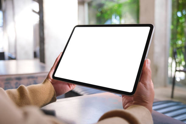 Mockup image of a woman holding digital tablet with blank desktop screen in cafe