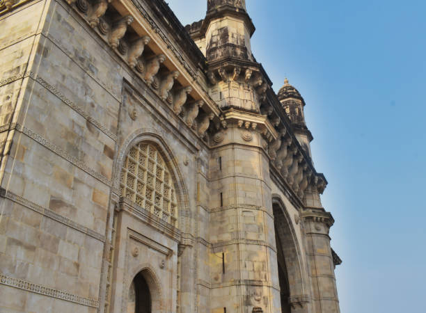 istock Elaborate stonework defines a grand archway that captures sunlight, showcasing detailed carvings and historical significance of Gateway of India 2196186914