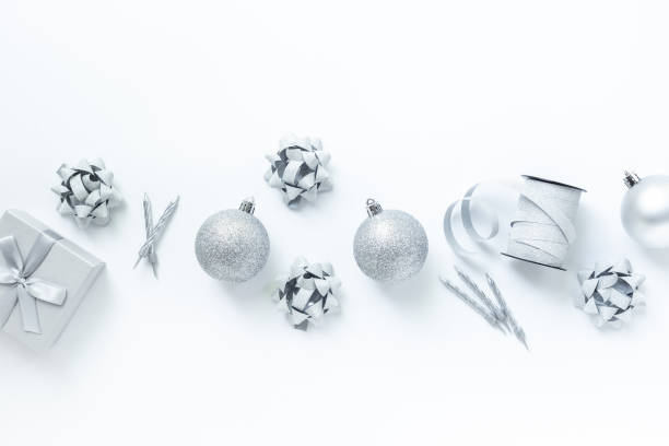 istock Silver colored Christmas and New Year decorations on white background, top view 2196187571