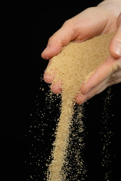 istock Hands pour crystalline cane brown unrefined healthy demerara sugar 2196187713