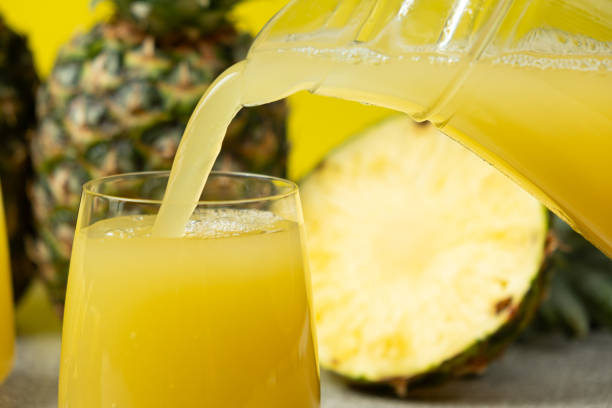 istock Pineapple juice is poured into a glass, a healthy vitamin drink. 2196187763