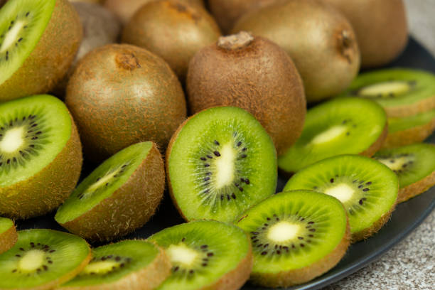 istock Plate of sliced and whole fresh kiwi fruit. 2196187898
