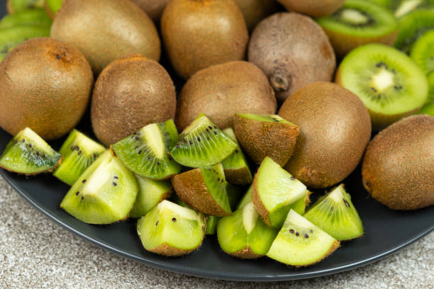 istock Plate of sliced and whole fresh kiwi fruit. 2196187899