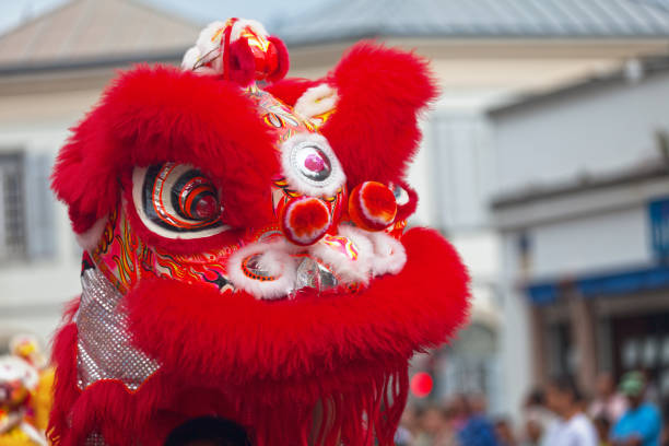 Chinese Lion Head in vibrant orange color on display. Close-up view. Celebration of the Chinese New Year or Spring Festival.