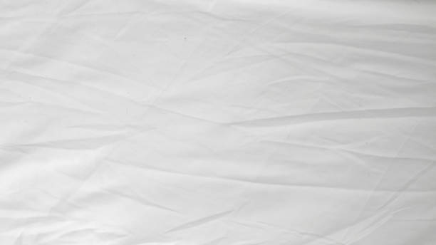 istock Soft and fluffy white linens on an unmade bed, highlighting minimalist design 2196189266