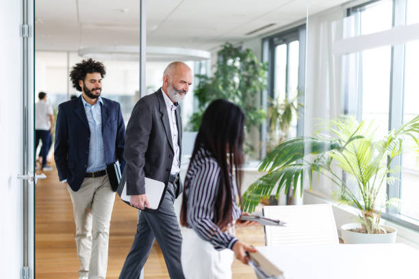 istock Business Professionals Walking in Modern Corporate Office 2196190286