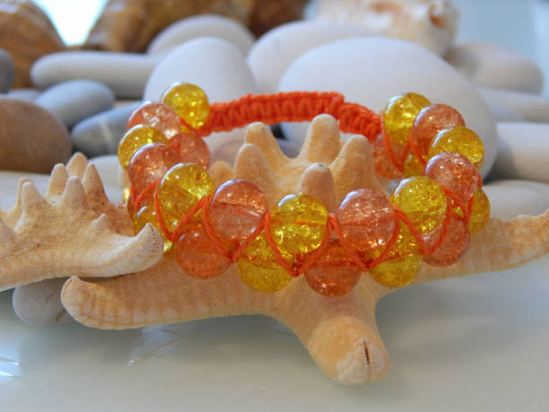 istock Hippie bracelet on sea stones 2196193002