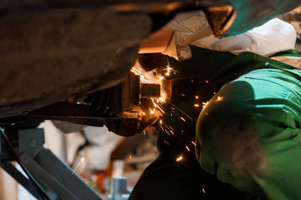 istock Skilled Mechanic Performing Precision Metalwork with Sparks Flying in Automotive Workshop 2196193059