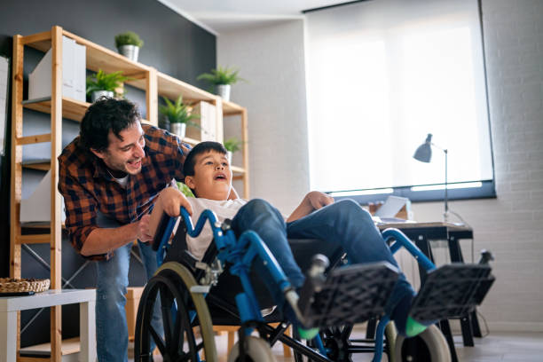 istock Single parent with asian child with disability in wheelchair 2196193330
