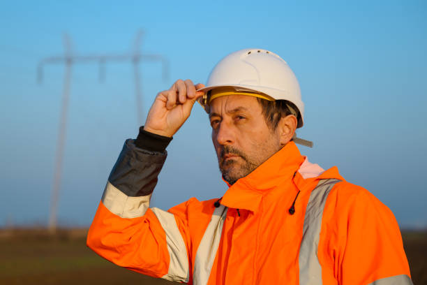 istock Portrait of electrical engineer in field wearing high visibility jacket and white hard hat 2196193652