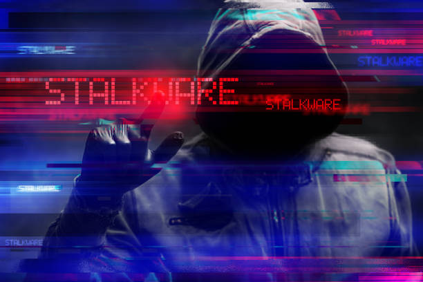 istock Stalkware concept with faceless hooded male person, low key image with digital glitch effect 2196194690