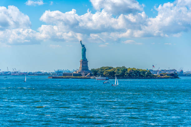 World famous Statue of Liberty under a cloudy sky. New York City, USA