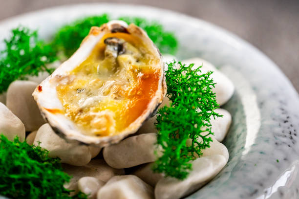 New Orleans, Louisiana in Mardi Gras Carnival Celebrations. Grilled oysters, seasoned with rich butter sauce, resting on a pristine white plate, ready to delight as a gourmet appetizer or a sumptuous main course