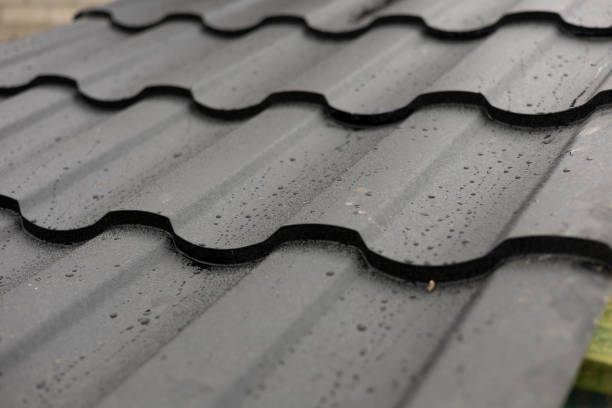 istock Raindrops gently slide off a sleek metallic rooftop, highlighting the unique wave pattern of the durable tiles designed for modern homes 2196199137