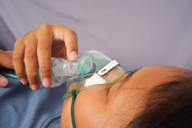 close up girls are breathless use nebulizer  lying on the sofa