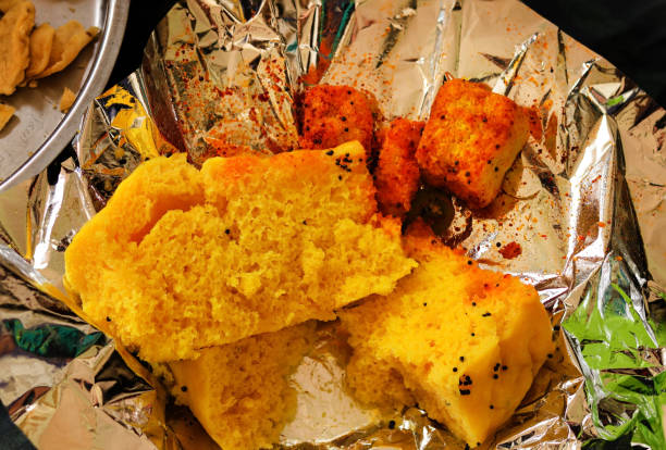 selective focus. Chana Dal Dhokla served with mint chutney. Gujarati Khaman Dhokla made using Chana Dal. Indian Traditional Street Food. Steamed Gram Flour Snack, [Dhokda] made from chick pea flour