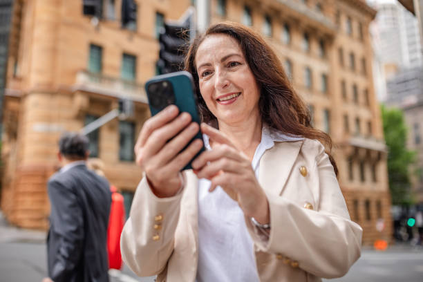 istock Adults navigating busy city life in Sydney while engaged with mobile technology in a professional setting 2196202672