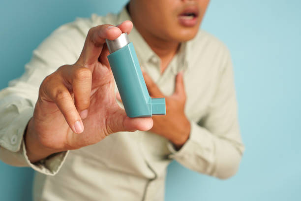 istock Man Holding an Inhaler While Experiencing Shortness of Breath 2196203899