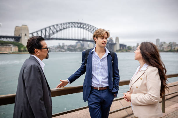 istock Business professionals engage in conversation while enjoying the Sydney waterfront views on a bustling day 2196204313