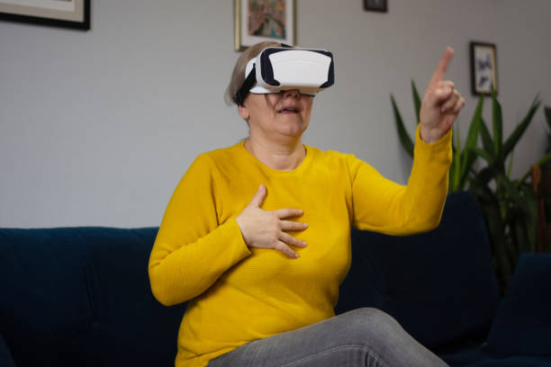 istock Mature woman wearing VR glasses 2196205275