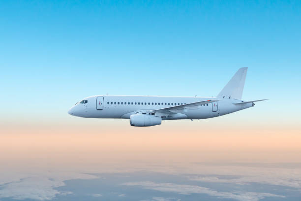 istock White passenger jetliner flying in the air above the clouds 2196205753