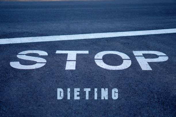 istock stop dieting concept. words written on a highway stop sign. 2196205797